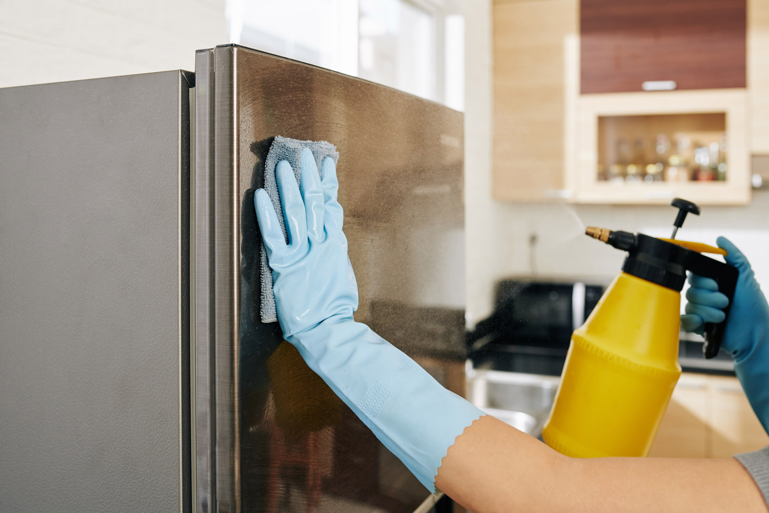 Woman cleaning refrigerator after hurricane damage